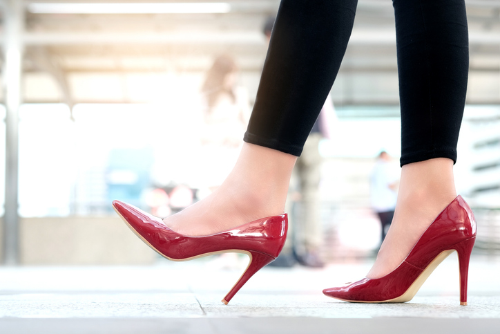 leg of woman beauty put on red high heels walk on the street.beauty and health concepts