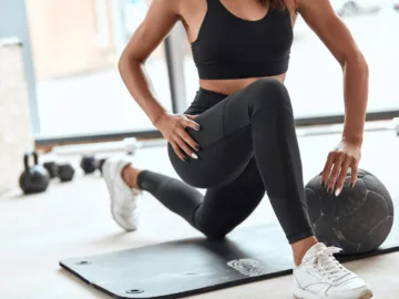 athlete stretching muscle legs in gym