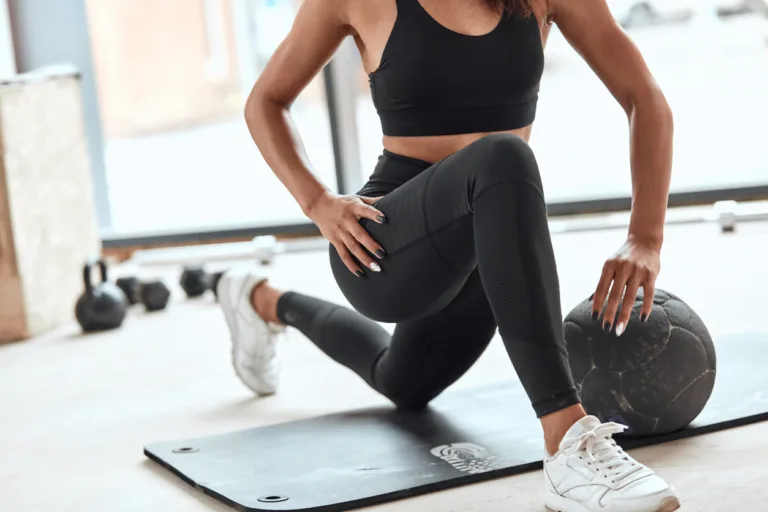 athlete stretching muscle legs in gym